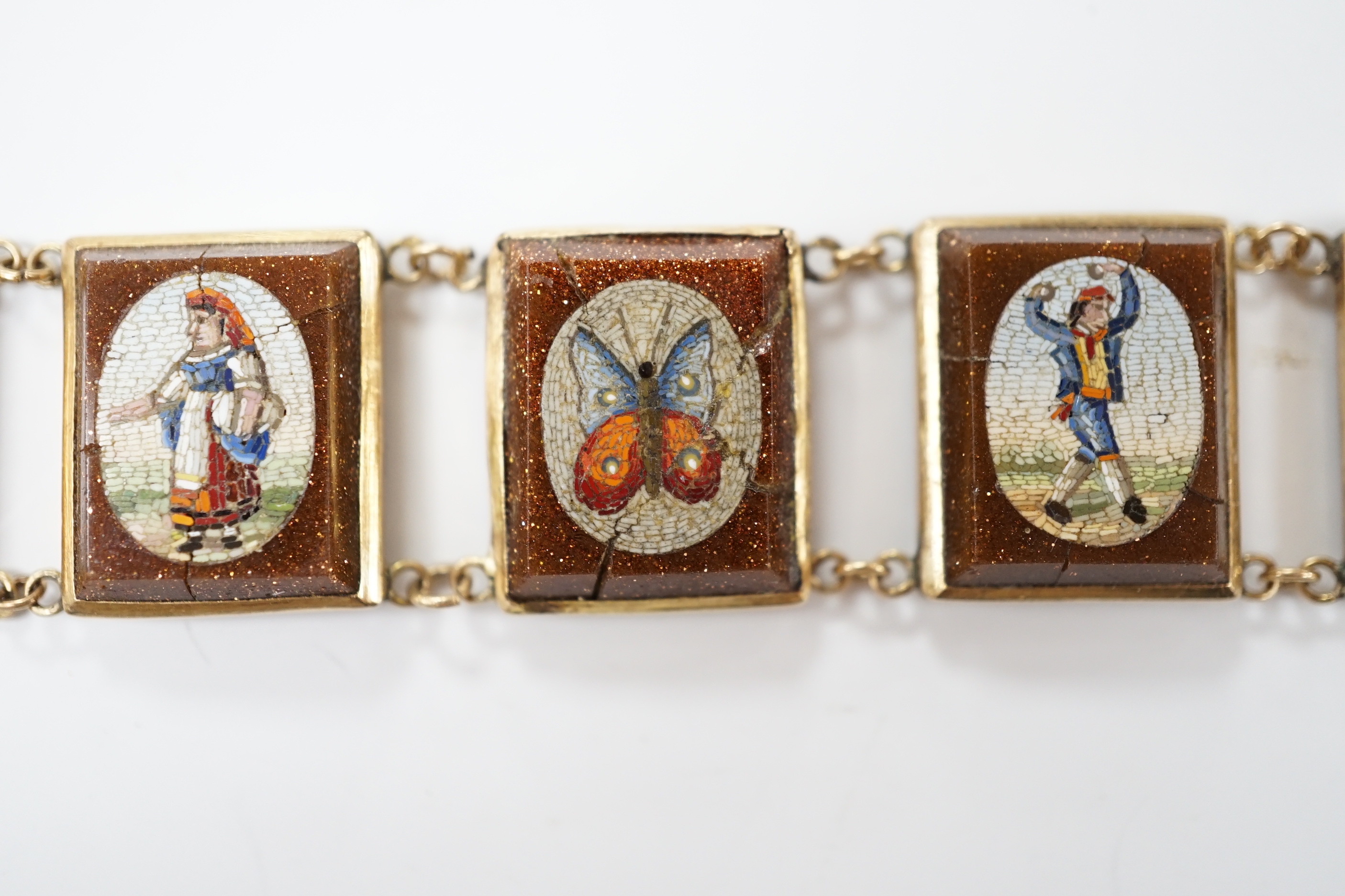 An Italian yellow metal, micro mosaic and goldstone set bracelet, with panels of Italian figures and insects, 17.3cm, gross weight 15.6 grams